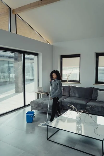 A man cleaning skyscraper windows with a harness, showcasing urban high-rise work.